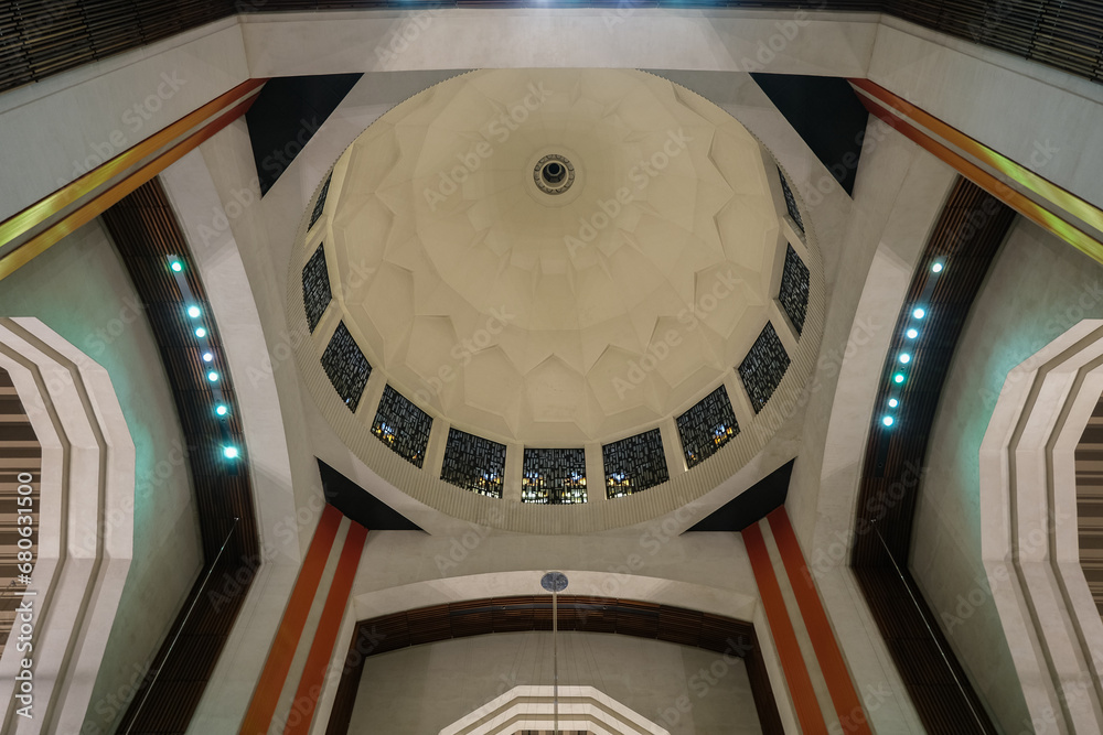 Obraz premium Art Deco interiors of Catholic minor basilica national shrine with massive dome and arch vaults, murals, altar and columns with Renaissance Revival style facade tourist pilgrim attraction