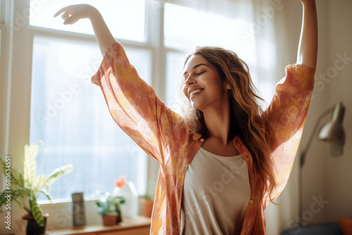 Joyful woman dancing alone in sunlit room with plants, carefree, grateful and happy.

 photo