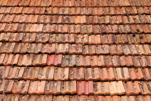 Roof top view. Red old tiles. The pattern of old roof tile. Orange old tile roof, abstract background. Roofing texture. Red corrugated tile element of roof. Seamless pattern.