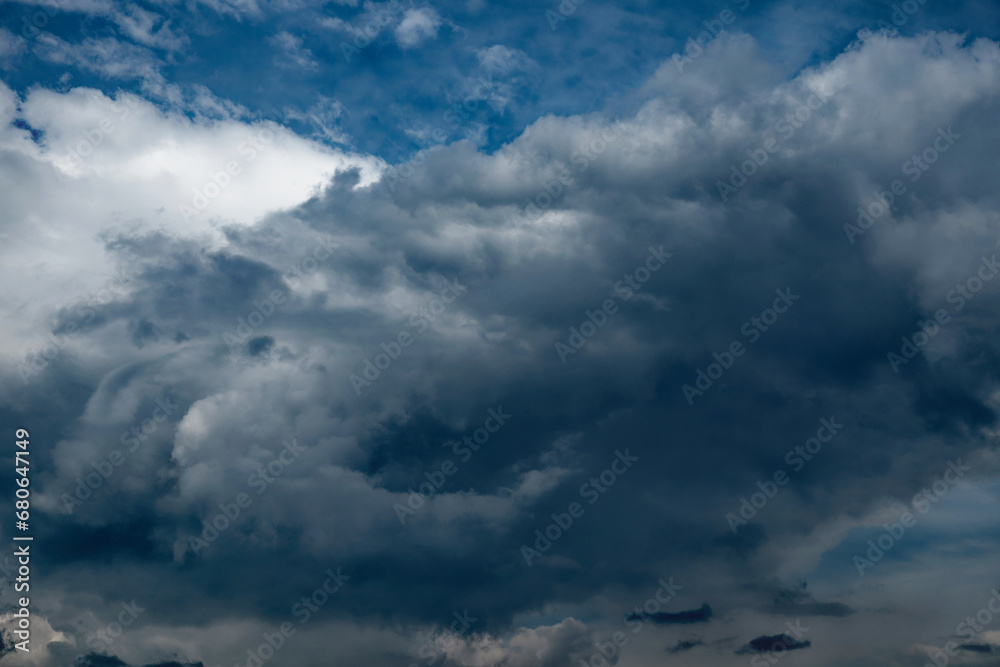 The sky is adorned with clouds of various shapes and sizes.