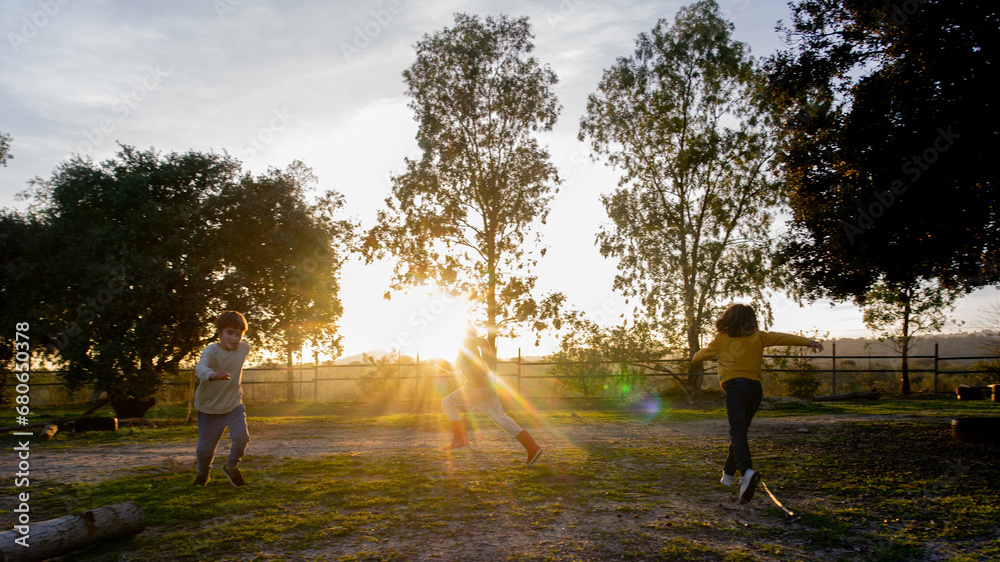 Children running outdoors at sunrise