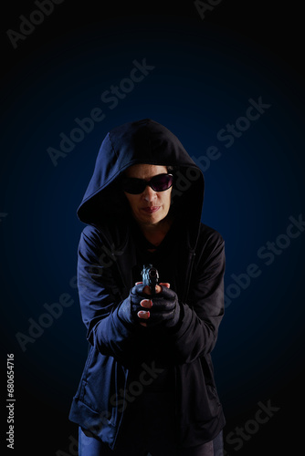 Person pointing gun Dark background