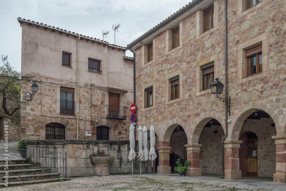 Stone buildings with semicircular arches and stairs in one of the corners of the Plaza de la Carcel in Sigüenza, province of Guadalajara. Spain