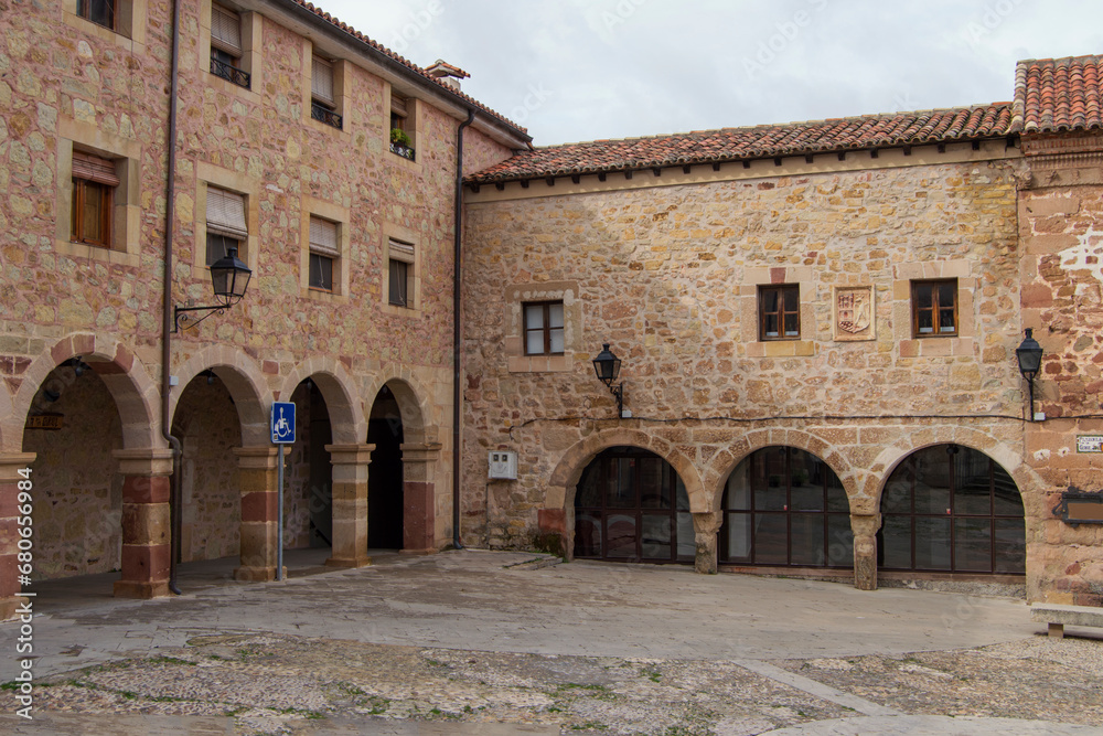Stone buildings with semicircular arches in one of the corners of the Plaza de la Carcel in Sigüenza, province of Guadalajara. Spain