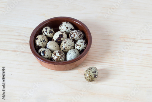 clay dish with quail eggs, isolated on white background