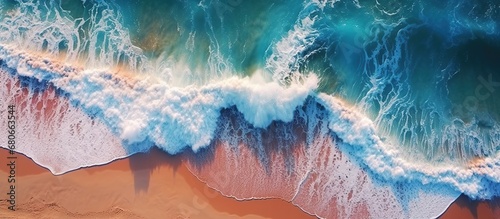 Aerial drone view of beautiful beach with turquoise ocean waves