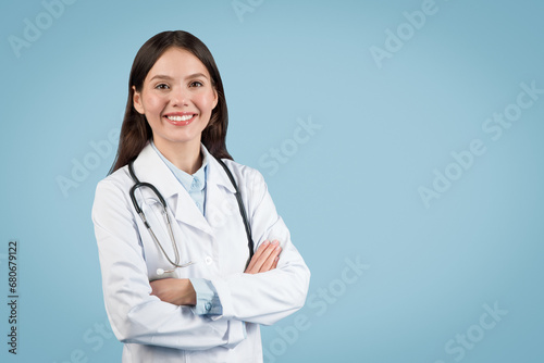 Smiling caucasian female doctor with arms crossed