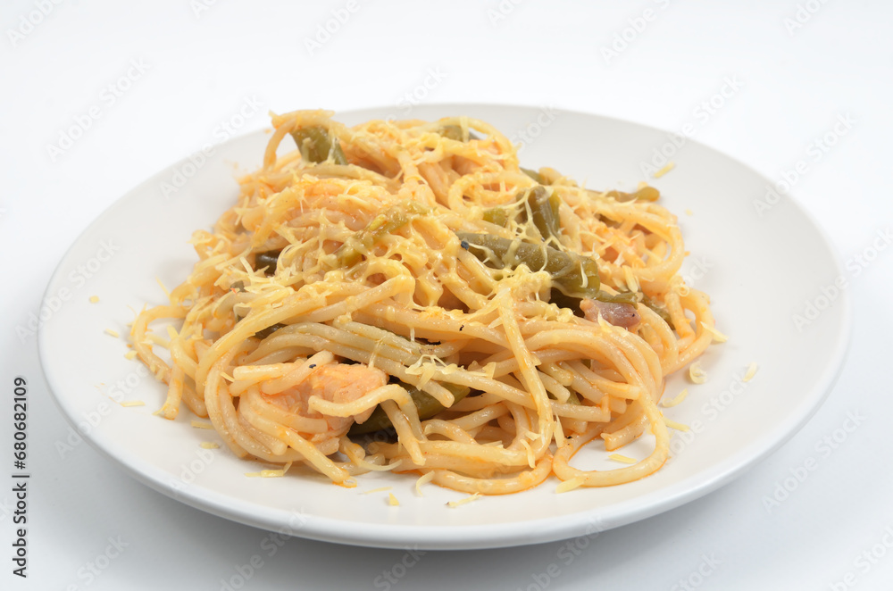 spaghetti with asparagus and meat stewed on a white plate