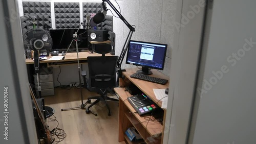 Recording studio, microphone close-up. Podcast recording, radio, dubbing, audio track. A small room with musical equipment, a computer monitor