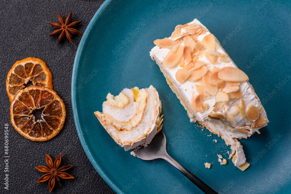 A piece of delicious sweet meringue roll with mascarpone cheese, berries and almonds A piece of delicious sweet meringue roll with mascarpone cheese, berries and almonds