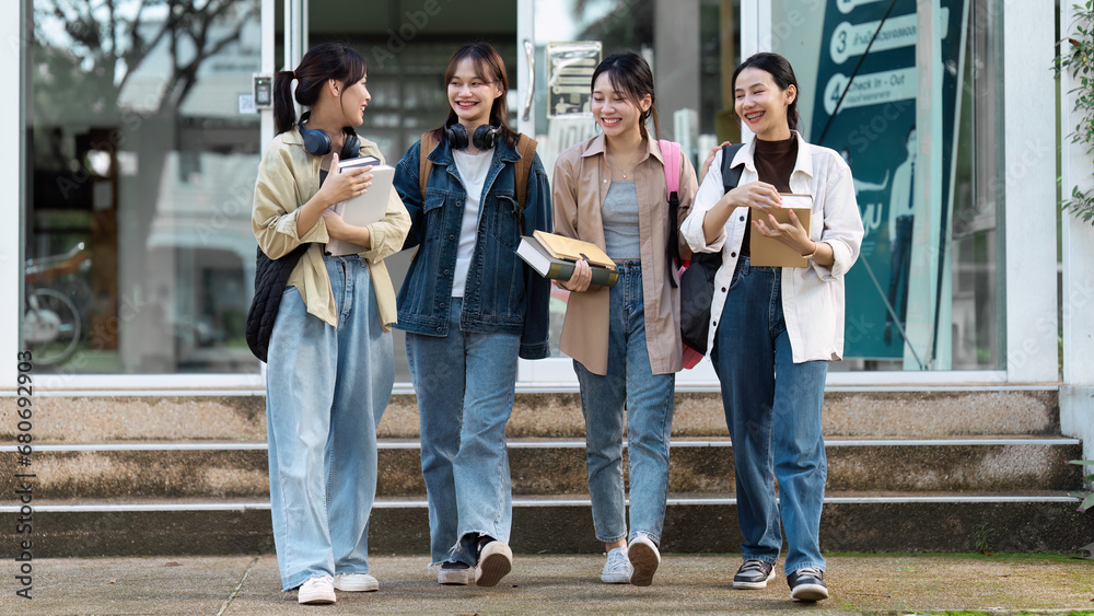 Obraz premium Group of Young Asian student walking and talking at university before class room. education, back to school concept