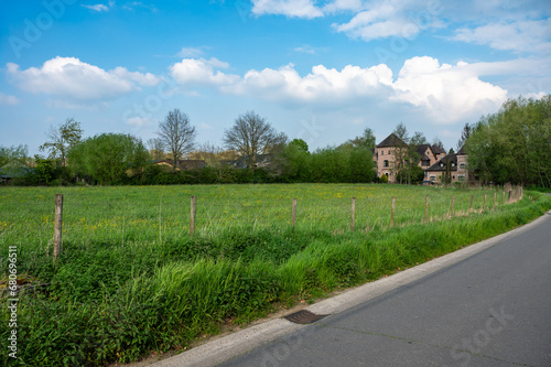 Green meadows with a rustic building in the background, Borchtlombeek, Brabant, Belgium photo