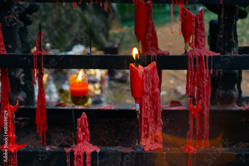 Red praying buddhist candles in park in Zhuji, China photo
