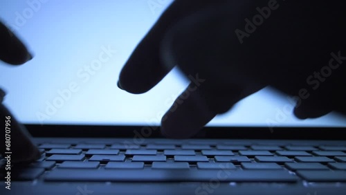 Anonymous Hands Typing in Darkness: Hacker or Coder Working Through the Night Against a Blue computer Screen