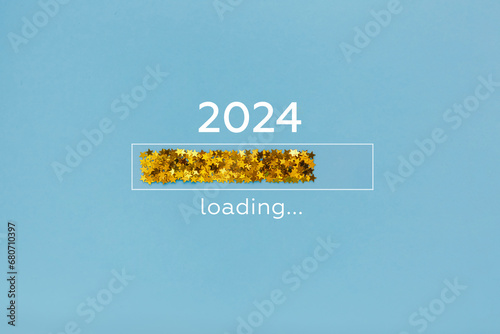 Loading year from 2023 to 2024. New year start concept with golden confetti decoration on blue background
