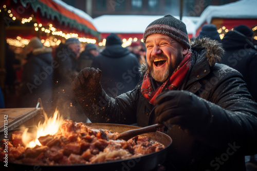 A man eating outside a food stall during german christmas market holiday photo