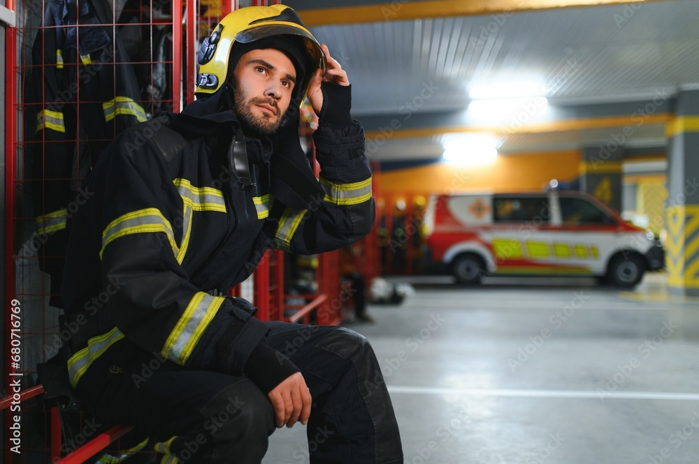 Portrait of male firefighter in uniform at fire station Portrait of male firefighter in uniform at fire station