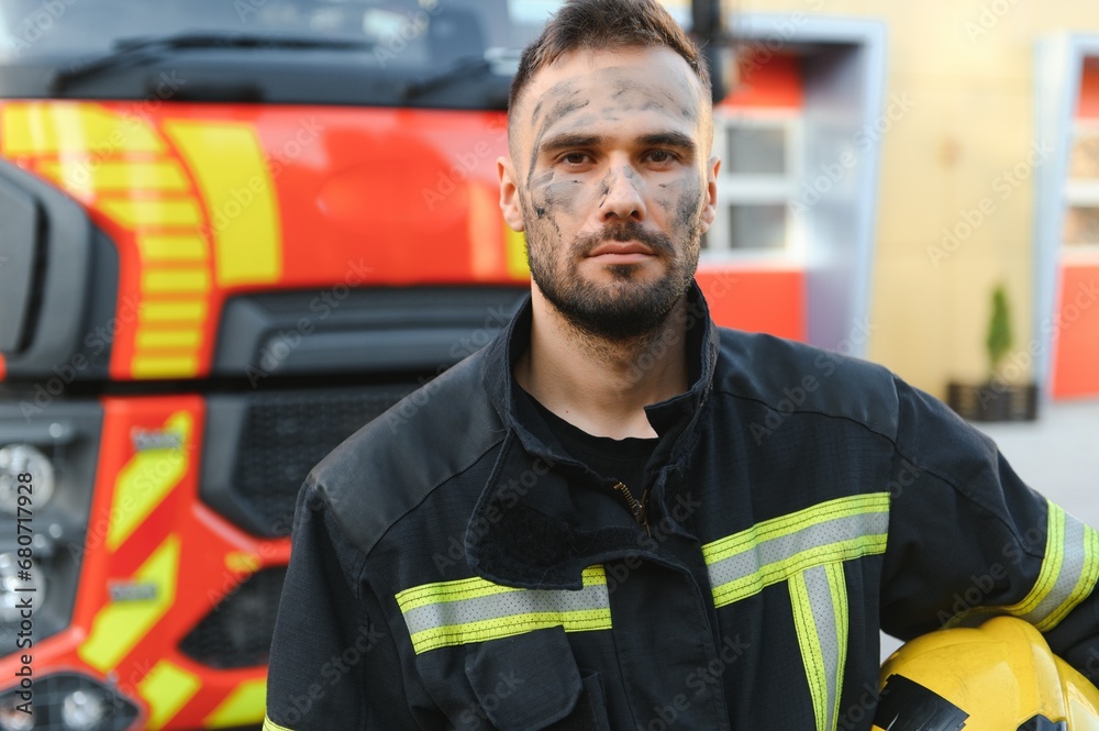 Firefighter rests after fighting a house fire Firefighter rests after fighting a house fire