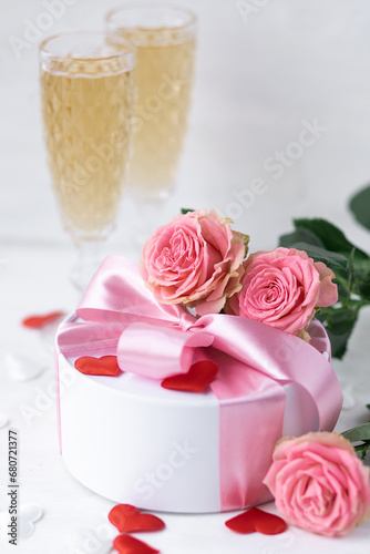 Beautiful surprise greeting for saint Valentine's or Women's Day, birthday or Anniversary for beloved. Fresh pink roses, gift box with sweets. White background. Holiday atmosphere