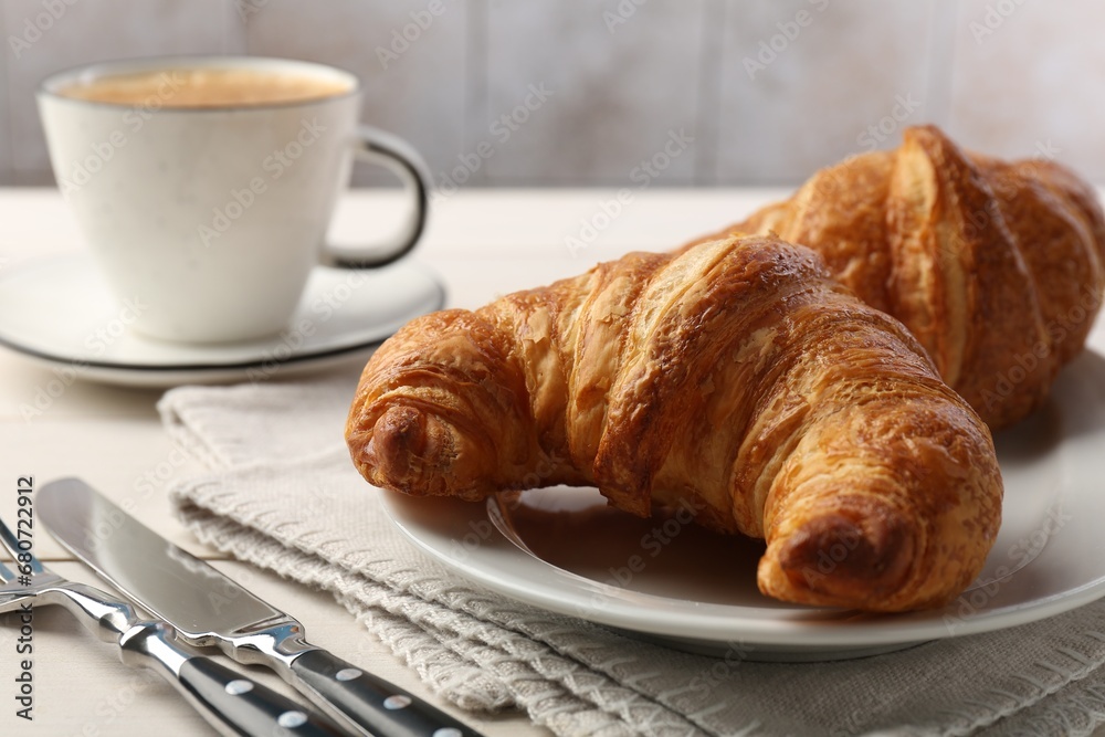 Delicious fresh croissants served on table, closeup