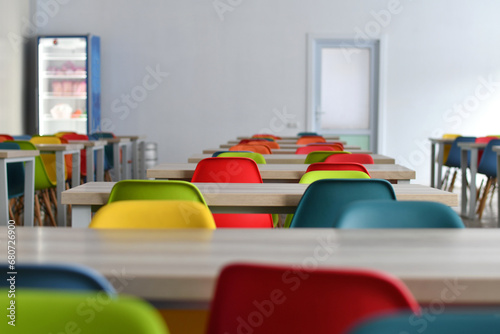 Colorful chairs in the empty school dining room. Selective focus.