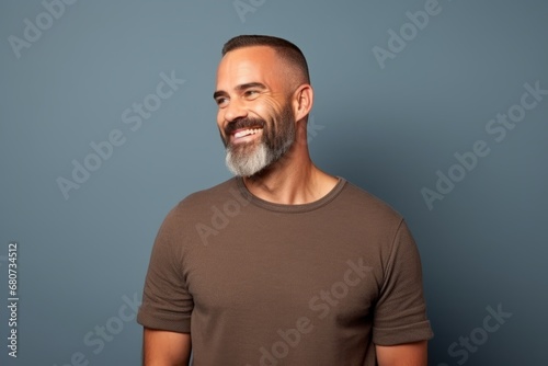 Portrait of a handsome middle-aged man smiling against blue background