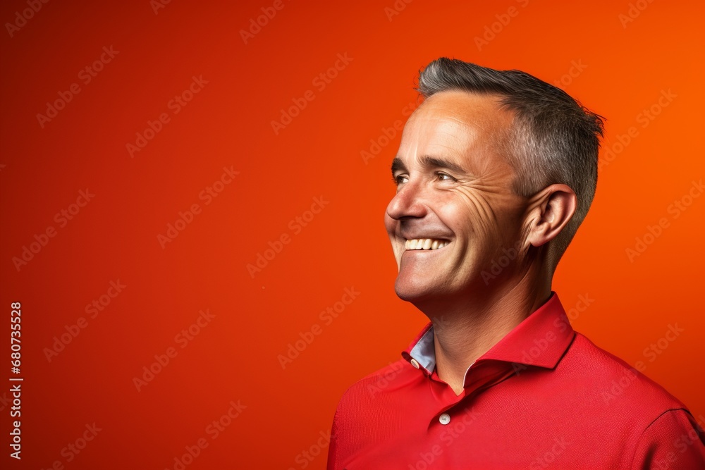 Portrait of a happy middle-aged man over red background. Portrait of a happy middle-aged man over red background.