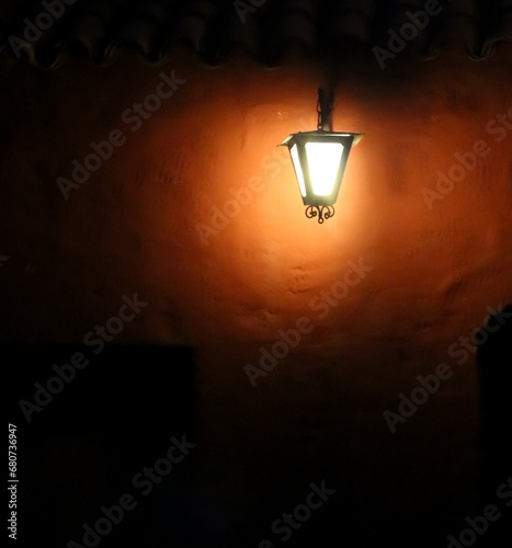 Bright street lantern with a very dark and myterious atmosphere in the Monasterio de Santa Catalina, Arequipa, Peru. photo