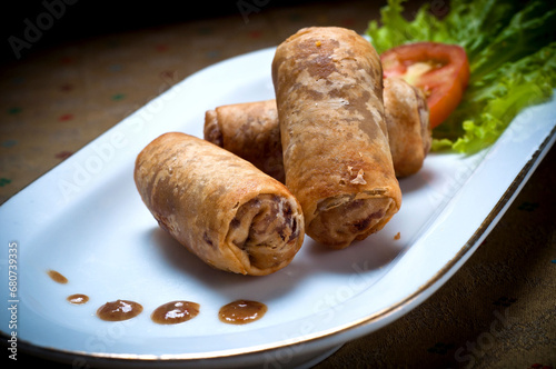 Picture of Risoles spring rolls filled with vegetables, typical Indonesian snack menu, taking pictures with decoration and artistic value, food photography