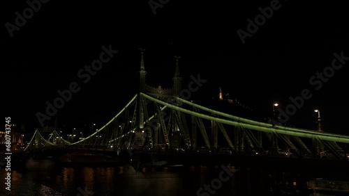 Illuminated liberty bridge at nightfall. A view of calm warm night with bright Liberty brisge in Budapest. photo