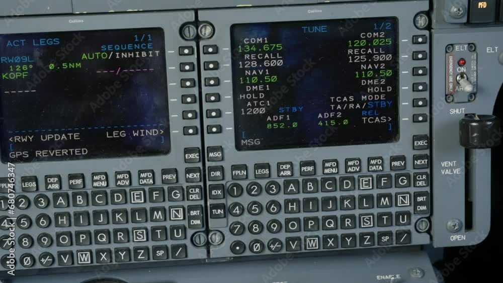 Trucking shot of pilot's control display units inside jet cockpit. Interface devices accessing Hawker's flight management computers Trucking shot of pilot's control display units inside jet cockpit. Interface devices accessing Hawker's flight management computers