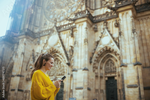 Canvas Print woman in Prague enjoying promenade, using phone and walking