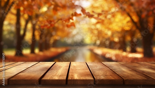 The empty wooden table top with blur background of autumn. Exuberant image.	 photo