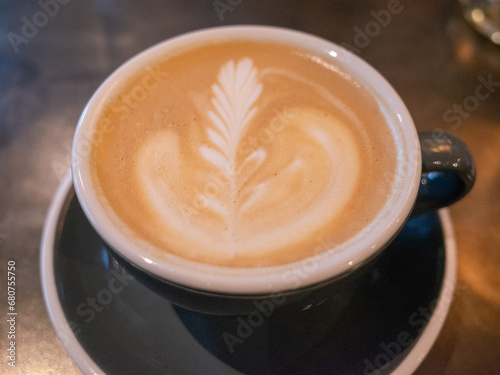 closed up latte art of cafe latte on the table in the cafe