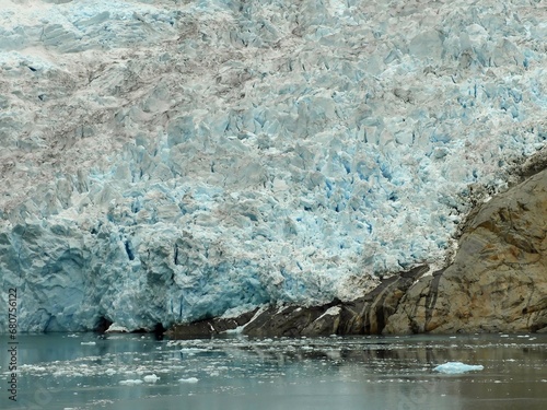 close up of the sermeq kajatleq glacier and icebergs in the steep mountains of the prince christian sound, in southern greenland, from a cruise ship photo
