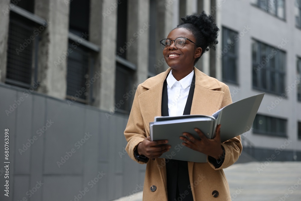 Happy woman with folders outdoors, space for text. Lawyer, businesswoman, accountant or manager Happy woman with folders outdoors, space for text. Lawyer, businesswoman, accountant or manager
