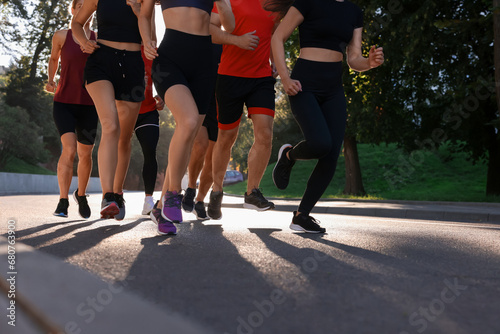 Group of people running outdoors on summer day, closeup