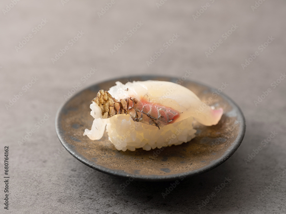 White fish sushi on a plate