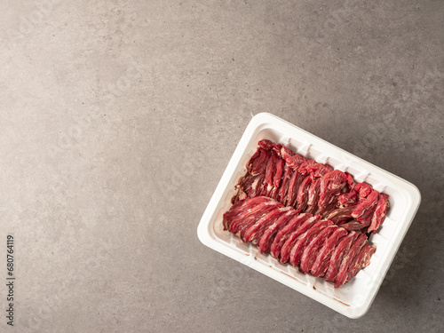 Fresh raw meat in disposable containers photo