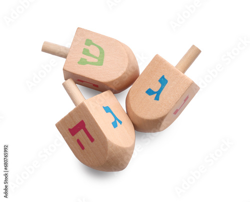 Wooden dreidels isolated on white, top view. Traditional Hanukkah game photo