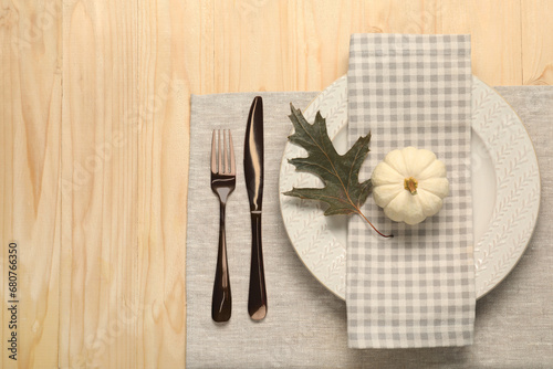 Autumn table setting, napkin and pumpkin, flat lay. Space for text