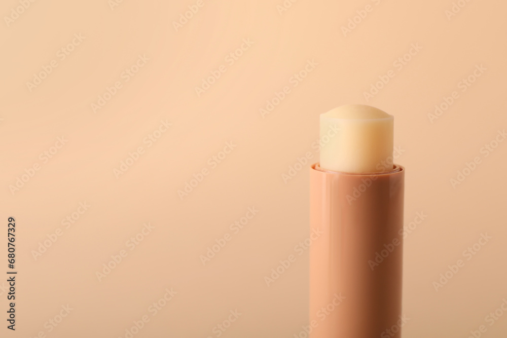 Lip balm on beige background, closeup. Space for text Lip balm on beige background, closeup. Space for text