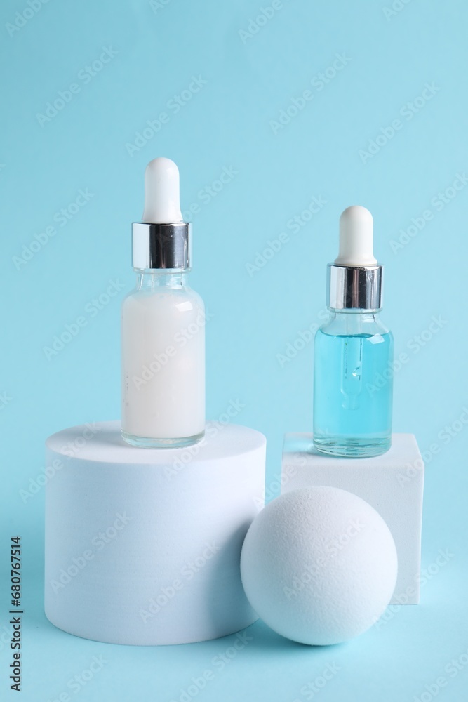 Stylish presentation of cosmetic serum on light blue background Stylish presentation of cosmetic serum on light blue background