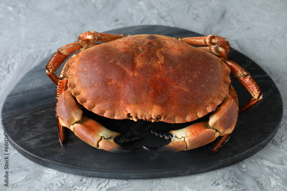 Delicious boiled crab on grey textured table, closeup Delicious boiled crab on grey textured table, closeup