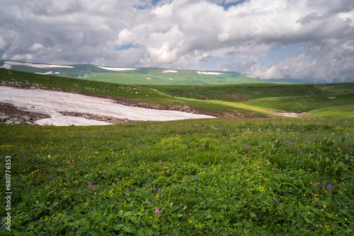 View of the alpine meadows of the Lago-Naki plateau in the mountains of the Western Caucasus on a sunny summer day, Caucasian Reserve, Republic of Adygea, Russia