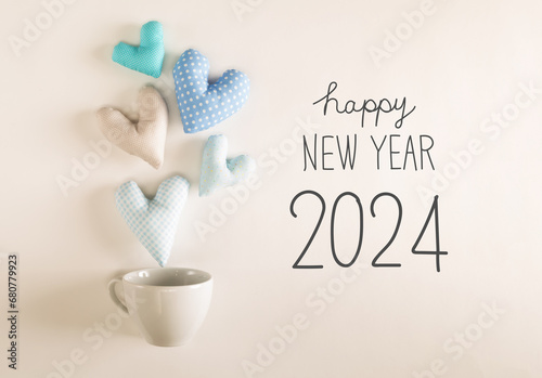 New Year 2024 message with blue heart cushions coming out of a coffee cup