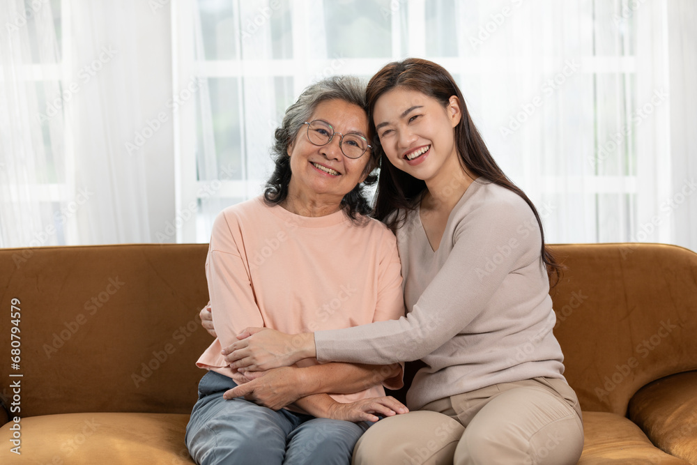 Heartfelt moment as a mid-age woman embraces her elderly mother with a warm and loving hug, celebrating the enduring bond between generations. Family Love Concept