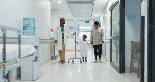 Medical, pediatrician and a doctor walking with a black family in a hospital corridor for diagnosis. Healthcare, communication and consulting with a medicine professional talking to a boy patient photo