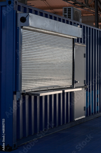 shuttered concession stand (ticket booth) closed for the season, metal gate lowered (shipping container construction) shutters photo
