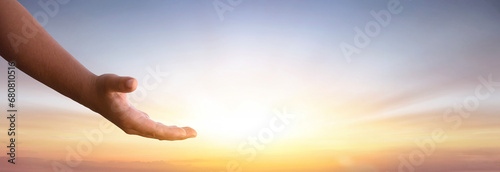 Jesus Christ reaching out with open arms to help in the sky background